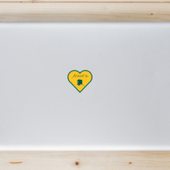 Alaska State Heart Shaped Laptop Sticker shown on a laptop lid