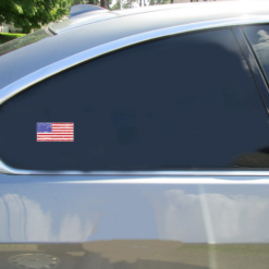 American Flag Distressed Car Sticker shown on a vehicle rear window