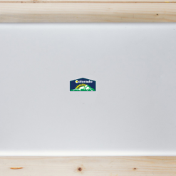 Colorado Mountains and Sunshine Laptop Sticker shown on a laptop lid