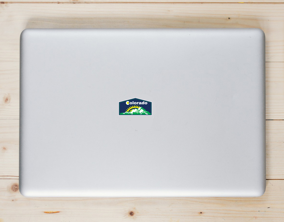 Colorado Mountains and Sunshine Laptop Sticker shown on a laptop lid