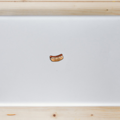 Don't Be A Wiener Hot Dog Laptop Sticker shown on a laptop lid
