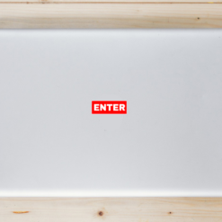 Enter Red Laptop Sticker shown on a laptop lid