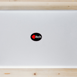 Heart Bitch Oval Laptop Sticker shown on a laptop lid