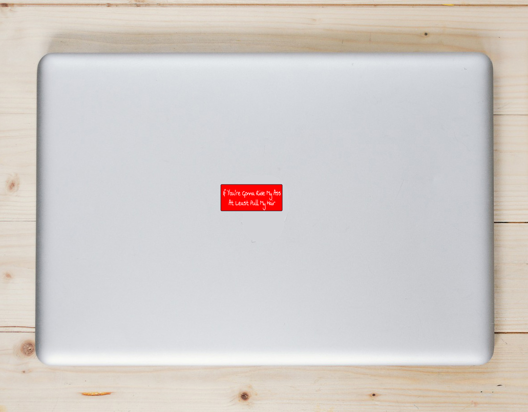 If You're Gonna Ride My Ass At Least Pull My Hair Laptop Sticker shown on a laptop lid