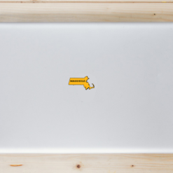 Masshole Gold Black State Shaped Laptop Sticker shown on a laptop lid
