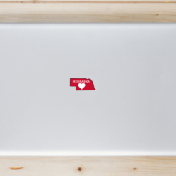 Nebraska Heart State Shaped Laptop Sticker shown on a laptop lid