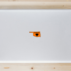 Oklahoma Heart State Shaped Laptop Sticker shown on a laptop lid
