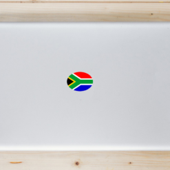 South African Flag Oval Laptop Sticker shown on a laptop lid