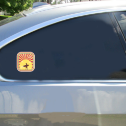 Surfer In Sunset Retro Car Sticker shown on a vehicle rear window