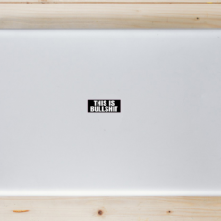 This Is Bullshit Black Laptop Sticker shown on a laptop lid
