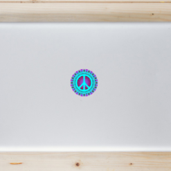 Trippy Peace Sign Circle Laptop Sticker shown on a laptop lid