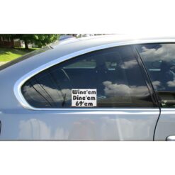 Wine'em Dine'em 69'em Car Sticker shown on a vehicle rear window