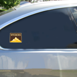 Wyoming Mountains State Shaped Car Sticker shown on a vehicle rear window